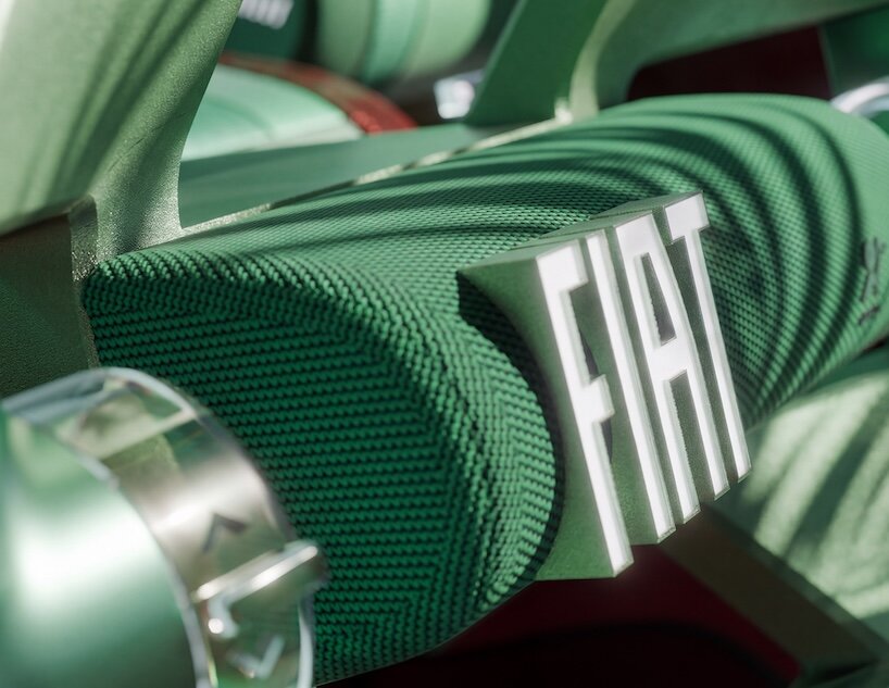 Логотип FIAT на зелёной текстильной поверхности интерьера
